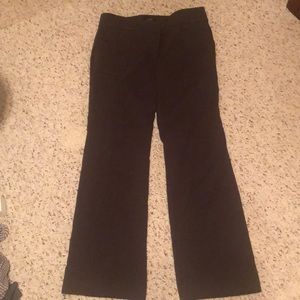 Dark olive trousers that flare with pockets